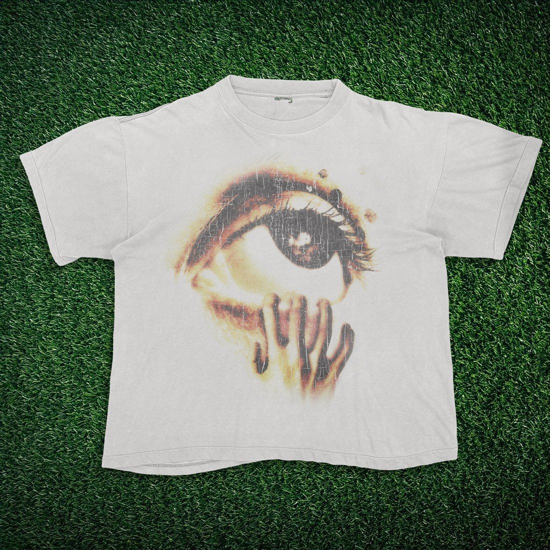 White tee with a distressed close-up eye graphic